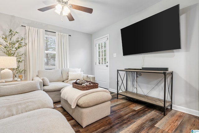 living room with ceiling fan and dark wood-type flooring