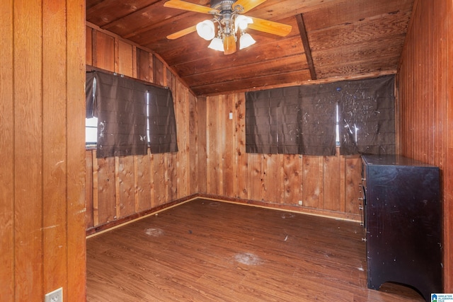 spare room with wooden walls, ceiling fan, wooden ceiling, and lofted ceiling