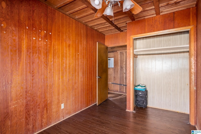 unfurnished bedroom with dark hardwood / wood-style flooring, wood ceiling, and wooden walls