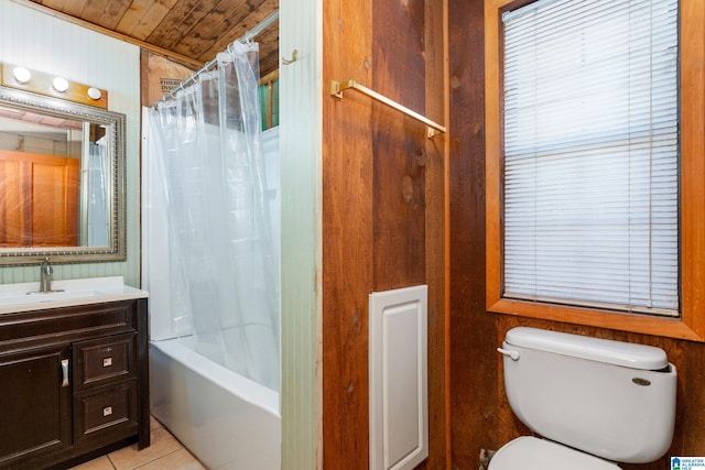 full bathroom featuring shower / bath combo, wood walls, vanity, tile patterned floors, and toilet