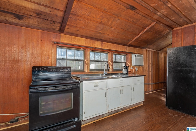 kitchen featuring black appliances, wood walls, wood ceiling, and sink