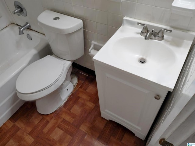 full bathroom featuring parquet flooring, vanity,  shower combination, tile walls, and toilet