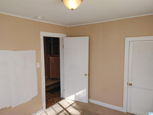 unfurnished room with carpet flooring and ornamental molding