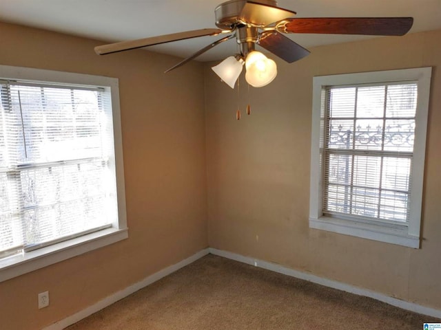 carpeted spare room with ceiling fan