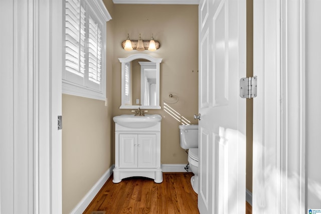 bathroom featuring vanity, toilet, and wood-type flooring