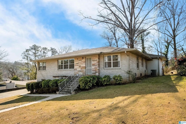 view of front of property with a front yard and cooling unit