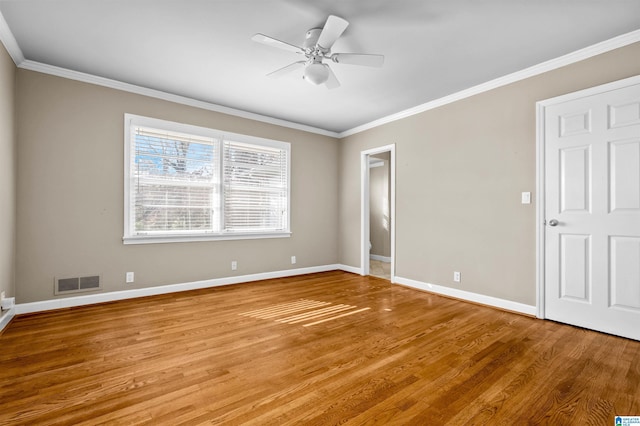 empty room featuring light hardwood / wood-style flooring, ceiling fan, and crown molding