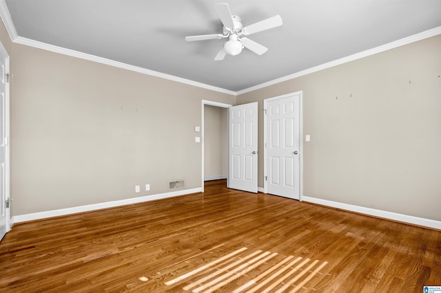 unfurnished bedroom with ceiling fan, wood-type flooring, and ornamental molding