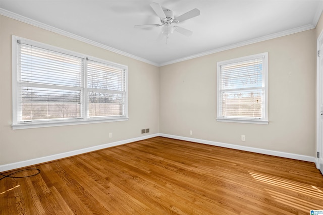 spare room with ceiling fan, ornamental molding, and light wood-type flooring