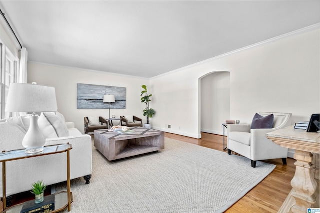 living room with ornamental molding and hardwood / wood-style flooring