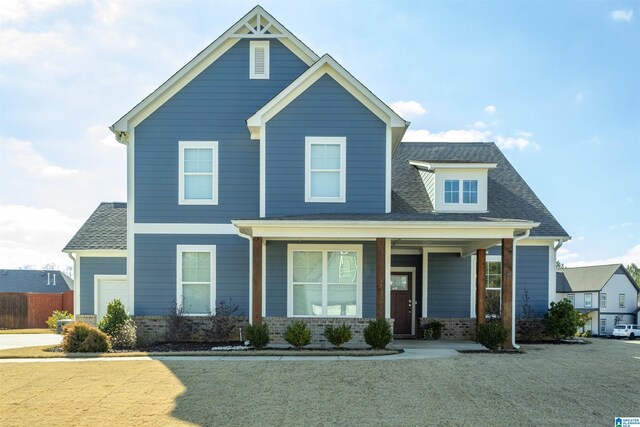 view of front of house with covered porch and a front yard