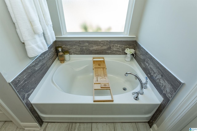 bathroom with a tub to relax in