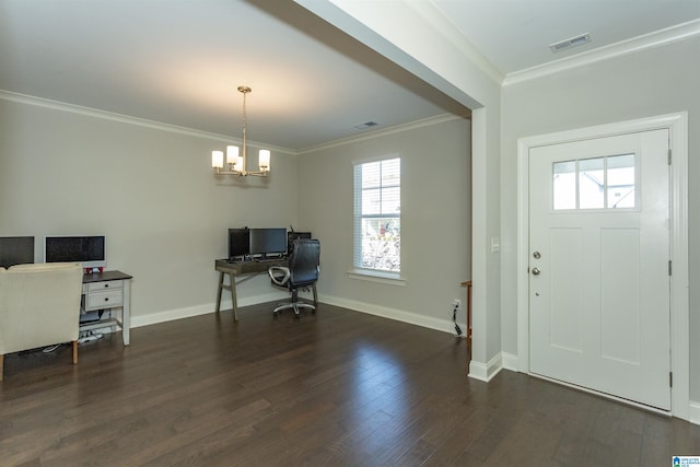 entrance foyer featuring dark hardwood / wood-style flooring, crown molding, and an inviting chandelier