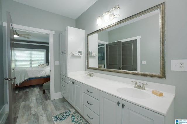 bathroom featuring ceiling fan, hardwood / wood-style floors, and vanity