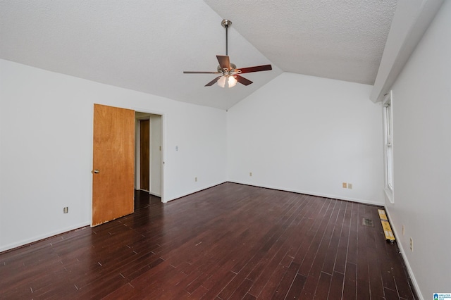 unfurnished living room featuring a textured ceiling, ceiling fan, dark wood-type flooring, and vaulted ceiling