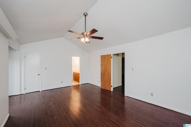 unfurnished room featuring a textured ceiling, vaulted ceiling, ceiling fan, and dark wood-type flooring