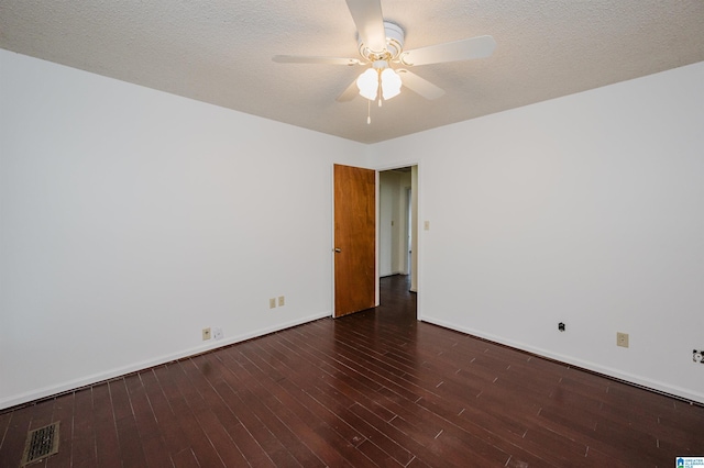 empty room featuring a textured ceiling, dark hardwood / wood-style floors, and ceiling fan