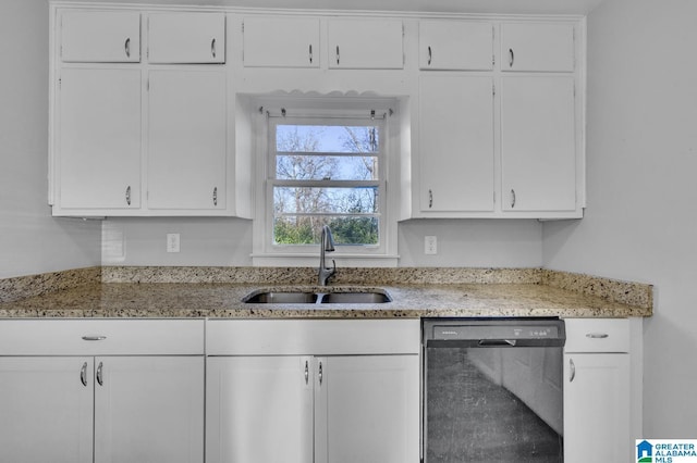 kitchen featuring black dishwasher, white cabinetry, and sink