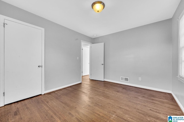 unfurnished bedroom with hardwood / wood-style flooring