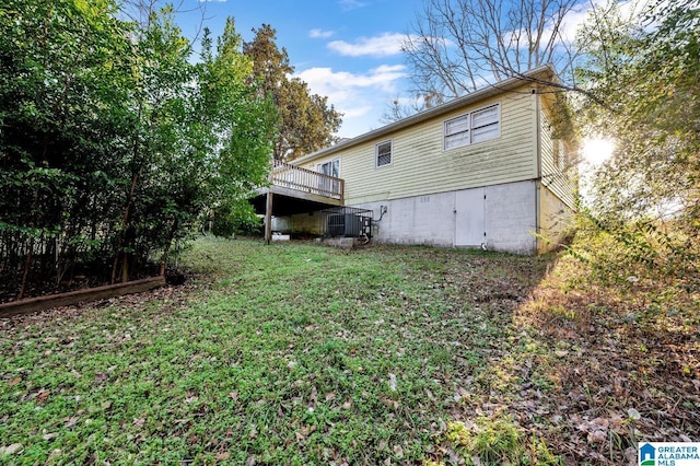 back of house with a lawn and a wooden deck