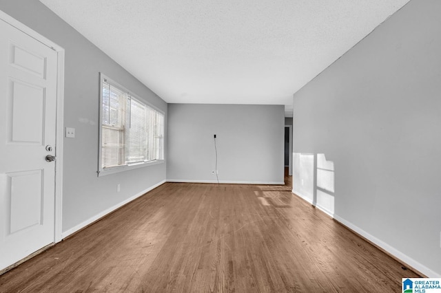 interior space with hardwood / wood-style floors and a textured ceiling