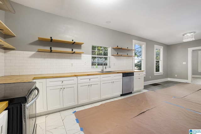 kitchen featuring stove, stainless steel dishwasher, sink, white cabinetry, and butcher block counters