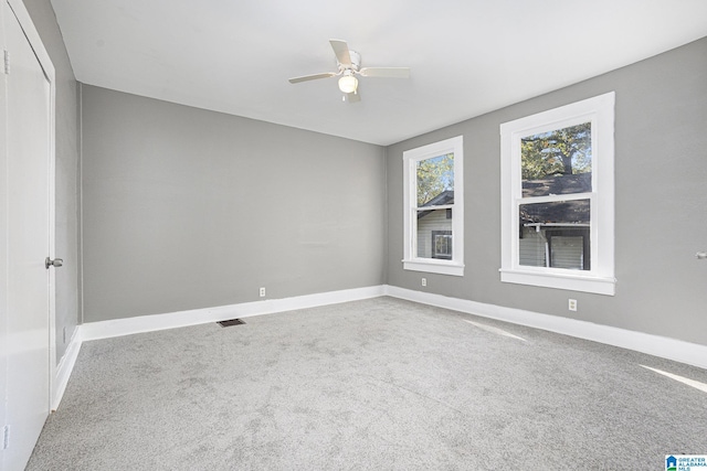 carpeted spare room featuring ceiling fan