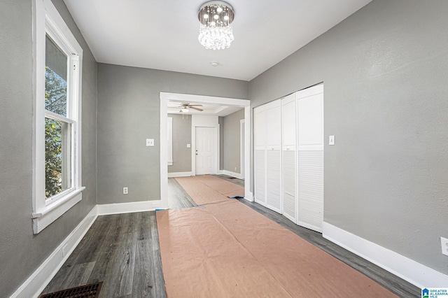 corridor featuring hardwood / wood-style floors and a notable chandelier