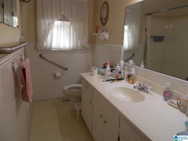 bathroom with vanity, toilet, and walk in shower