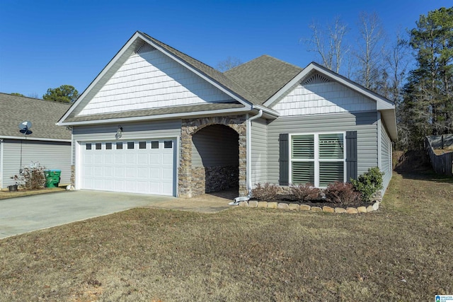 craftsman-style house featuring a garage and a front yard