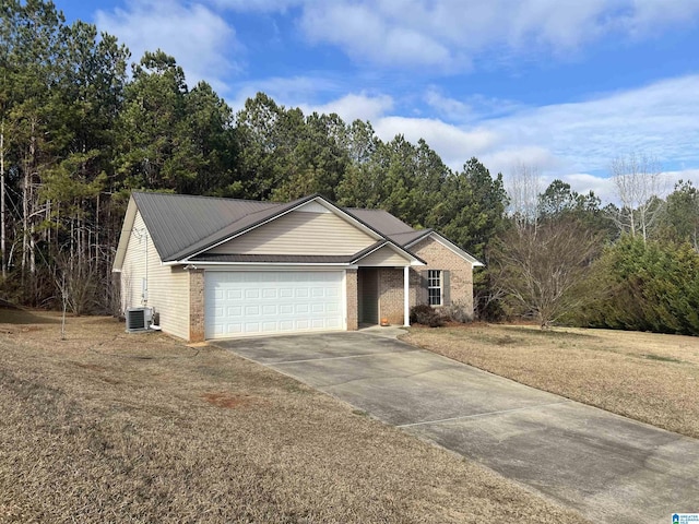 view of front of house featuring central AC and a garage