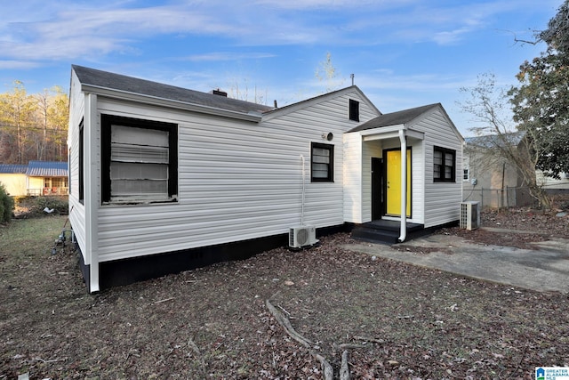 view of front facade with ac unit and central AC