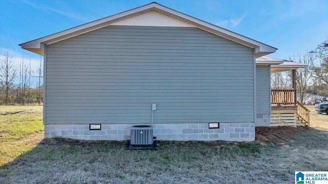 view of property exterior with a lawn and central air condition unit