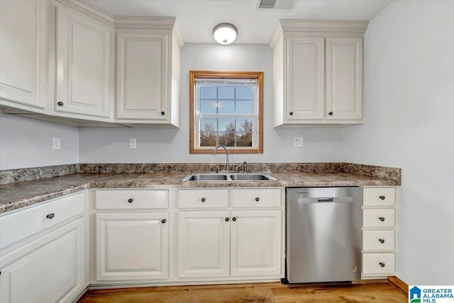 kitchen with dishwasher, white cabinets, and sink