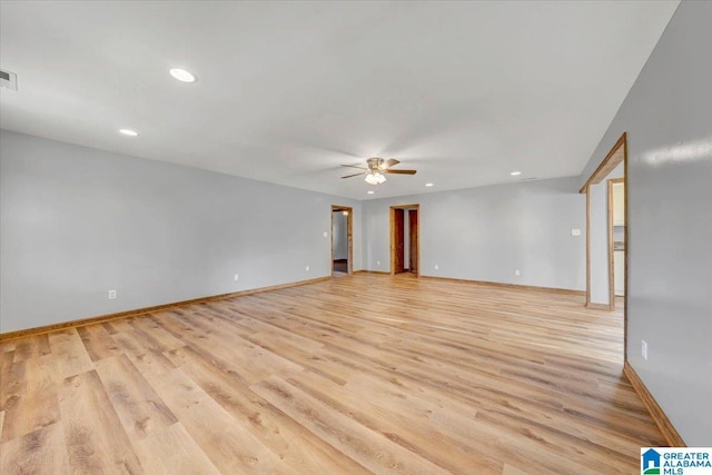 empty room featuring ceiling fan and light hardwood / wood-style flooring