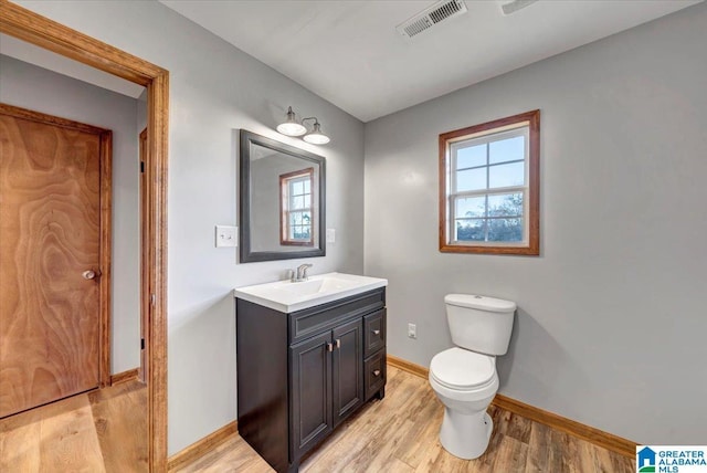 bathroom with vanity, hardwood / wood-style flooring, and toilet