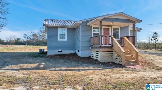 view of front facade with a porch and central AC unit