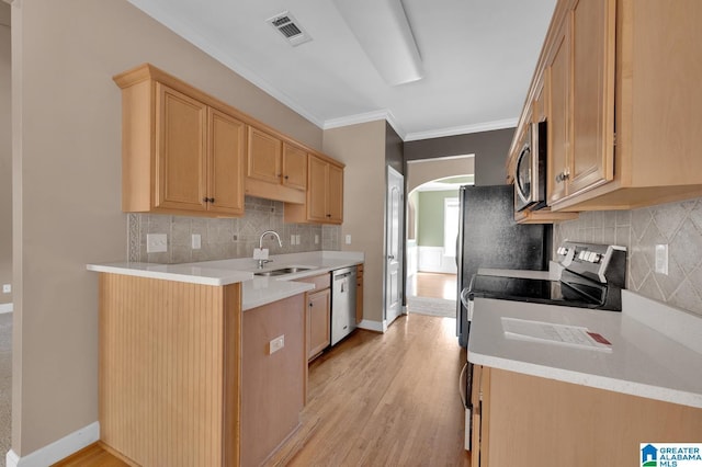 kitchen featuring sink, crown molding, light brown cabinetry, appliances with stainless steel finishes, and light wood-type flooring