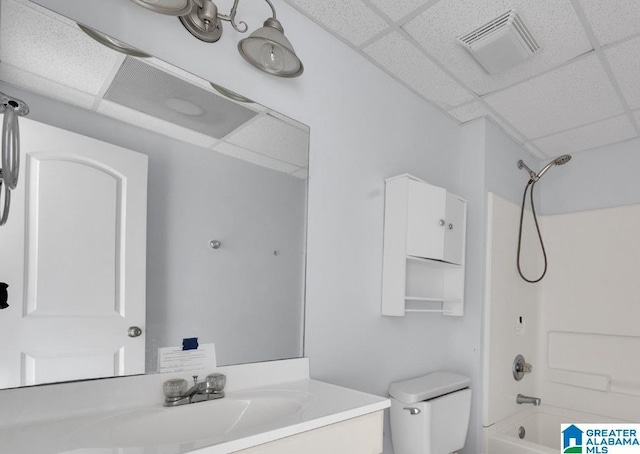 full bathroom with vanity, toilet, shower / washtub combination, and a drop ceiling