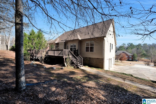 back of property with a deck and a garage