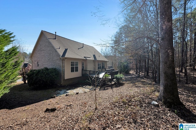 back of house with a deck