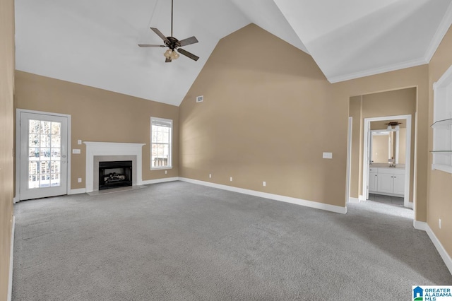 unfurnished living room with light carpet, high vaulted ceiling, a wealth of natural light, and ceiling fan