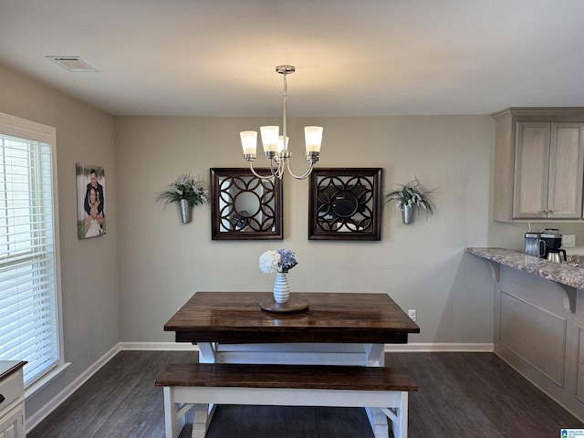 dining space featuring a notable chandelier and dark wood-type flooring