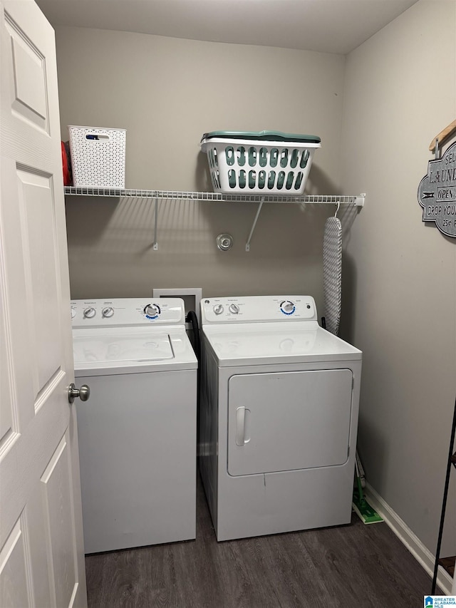 laundry room with dark wood-type flooring and washer and dryer