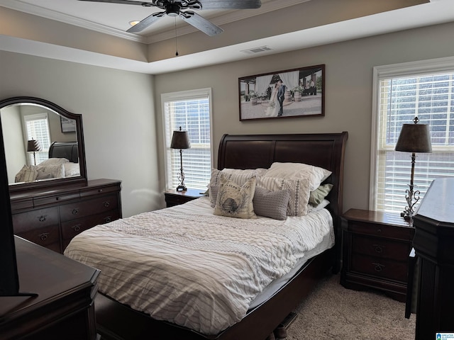 carpeted bedroom with ceiling fan and ornamental molding