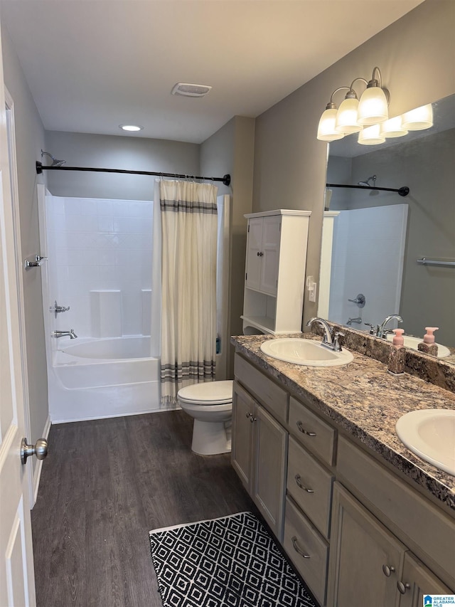 full bathroom featuring hardwood / wood-style floors, shower / bath combo, toilet, and vanity