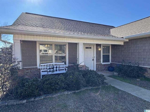 view of exterior entry featuring covered porch