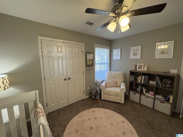 bedroom with a closet, dark carpet, and ceiling fan