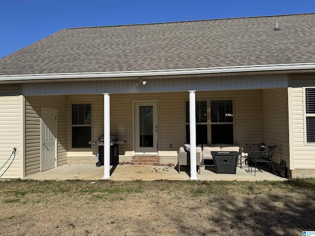 back of property with an outdoor living space and a patio