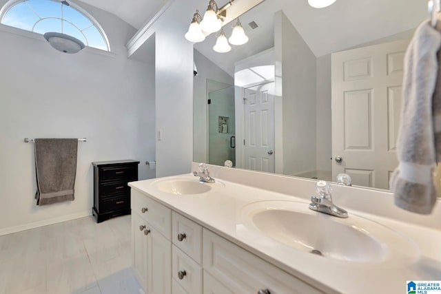 bathroom featuring lofted ceiling, vanity, and a shower with shower door